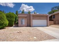 Charming single-story home with a two-car garage, rock landscaping, and well-maintained front yard at 1117 W Manor St, Chandler, AZ 85224