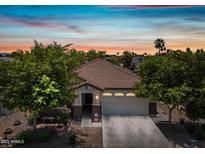 Charming single-story home showcasing a tile roof and well-maintained landscaping at 1344 N Claiborne --, Mesa, AZ 85205