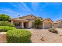 Inviting single-story home featuring desert landscaping and a covered front porch at 19697 N 66Th Ave, Glendale, AZ 85308