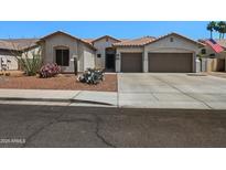 Charming single-story home boasts a three-car garage, well-kept desert landscaping, and a cozy front entryway at 2270 E Indian Wells Dr, Chandler, AZ 85249
