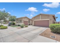 Spacious two-car garage, well-manicured lawn, and mature trees enhance curb appeal at 22927 E Via Del Oro --, Queen Creek, AZ 85142