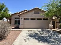 Charming single-story home with a two-car garage and well-maintained landscaping at 22963 W La Pasada Blvd, Buckeye, AZ 85326