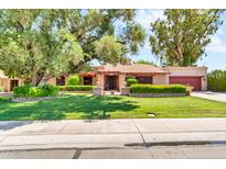 Charming single-story home with a well-manicured front yard and mature trees at 3027 N Nebraska St, Chandler, AZ 85225