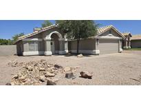 Charming single-story home featuring a well-maintained front yard and an attached two-car garage at 3446 N Ravine --, Mesa, AZ 85215