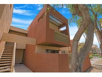 Modern, multi-story home featuring a private balcony with unique lattice work and a tree in the foreground at 3500 N Hayden Rd # 2110, Scottsdale, AZ 85251