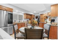 Bright eat-in kitchen featuring stainless steel appliances, granite countertops, and custom wood cabinets at 5402 E Mckellips Rd # 237, Mesa, AZ 85215