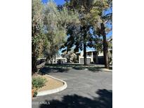 A street view featuring townhomes, mature trees, and well-maintained landscaping, enhancing curb appeal and community charm at 618 E Manzanita Pl, Phoenix, AZ 85020