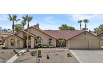 Charming single-story home featuring a tile roof, desert landscaping, and a welcoming front entrance at 6249 E Camelot Dr, Mesa, AZ 85215
