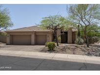 Charming single-story home featuring a three-car garage and desert landscaping, located in a desirable neighborhood at 6917 E Night Glow Cir, Scottsdale, AZ 85266