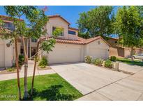 Charming townhouse featuring a two-car garage and a well-maintained front yard at 1121 W Windjammer Dr, Gilbert, AZ 85233