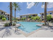 Resort-style pool with lush landscaping, palm trees, and lounge seating in a beautiful apartment complex at 11640 N Tatum Blvd # 2013, Phoenix, AZ 85028