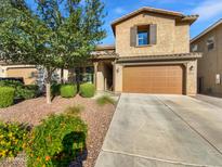 Charming two-story home featuring desert landscaping, a two car garage, and a covered front porch entrance at 12211 W Prickly Pear Trl, Peoria, AZ 85383