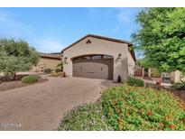 Attached two car garage with brick paved driveway and colorful landscaping adds to the curb appeal of this home at 12738 W Brookhart Way, Peoria, AZ 85383