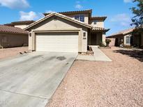 Charming two-story home featuring a two-car garage and desert landscaping at 12801 N El Frio St, El Mirage, AZ 85335