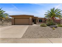 Charming single-story home featuring a desert landscape, two-car garage and a neutral color palette at 16716 W Rincon Peak Dr, Surprise, AZ 85387