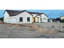 Charming single-story home featuring a stucco exterior, tiled roof, and decorative wrought iron door at 22504 W Meade Ln, Buckeye, AZ 85326