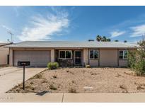 Charming single-story home with desert landscaping, attached garage and stone accents at 3208 W Wagoner Rd, Phoenix, AZ 85053