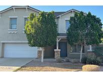 Charming two-story home with a well-manicured front yard and inviting entryway at 38242 N Armadillo Dr, San Tan Valley, AZ 85140
