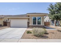 Charming single-story home featuring a two-car garage and low maintenance desert landscaping at 41279 W Elm Dr, Maricopa, AZ 85138