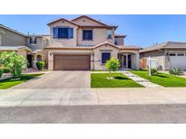 Charming two-story home featuring a well-maintained lawn and attached two-car garage at 550 E Zion Pl, Chandler, AZ 85249