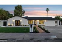 Charming home boasts fresh landscaping, updated lighting fixtures, and a well-manicured front yard at 8403 E Fairmount Ave, Scottsdale, AZ 85251