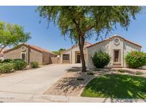 Charming single-story home featuring a well-manicured lawn and mature landscaping at 8628 W Maui Ln, Peoria, AZ 85381