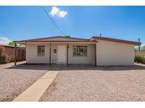 Charming single-story home with a gravel yard, offering a clean, low-maintenance landscape at 122 N 5Th St, Avondale, AZ 85323