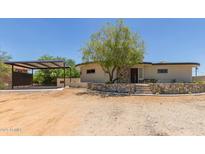 Unique home boasts desert landscaping, carport, and stone accents for rustic desert charm at 1545 E Christy Dr, Phoenix, AZ 85020