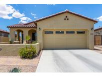 Charming home featuring desert landscaping, covered porch, and a two-car garage at 16756 S 181St Ln, Goodyear, AZ 85338