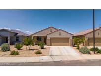 Charming single-story home featuring desert landscaping and a two-car garage at 16824 W Alice Ave, Waddell, AZ 85355