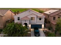Charming two-story home featuring a private driveway, desert landscaping and an attached two-car garage at 19182 N Smith Dr, Maricopa, AZ 85139