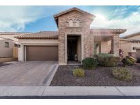 Charming brick home featuring a two-car garage and inviting front entrance at 2065 N Red Clf, Mesa, AZ 85207
