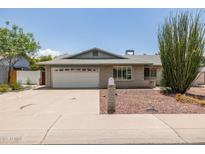 Charming single-story brick home with a two-car garage, and xeriscaping at 2119 E Sesame St, Tempe, AZ 85283