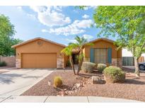 Charming single-story home featuring a well-manicured front yard and a two-car garage at 2124 W Harwell Rd, Phoenix, AZ 85041