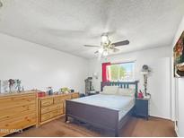 Spacious bedroom featuring a ceiling fan, natural light and neutral walls at 4122 W Las Palmaritas Dr, Phoenix, AZ 85051