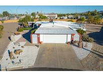 Charming home featuring a white facade, two-car garage, and desert landscaping at 420 S 80Th Pl, Mesa, AZ 85208