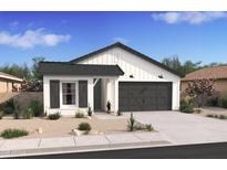 Charming single-story home with white board and batten siding, gray trim, desert landscaping, and a two-car garage at 42510 W Peters Dr, Maricopa, AZ 85138