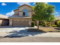 Charming two-story home features a well-manicured front yard and a spacious two-car garage, with a beautiful facade at 4626 E Summerhaven Dr, Phoenix, AZ 85044