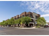 Beautiful exterior shot of a brick condominium building on a sunny day with a clear blue sky at 475 N 9Th St # 206, Phoenix, AZ 85006
