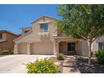 Charming two-story home with a three-car garage and inviting covered front porch at 5208 W Straight Arrow Ln, Phoenix, AZ 85083