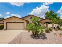 Charming single-story home with a two-car garage and low-maintenance desert landscaping at 6420 W Beverly Ln, Glendale, AZ 85306