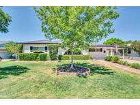 Desirable single-story house boasts a lush green lawn, mature trees, and a welcoming front entrance with excellent curb appeal at 6808 N 11Th St, Phoenix, AZ 85014
