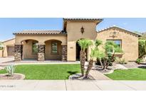 Beautiful single-story home featuring a tile roof, manicured landscaping, and a charming front entrance at 7242 W Rowel Rd, Peoria, AZ 85383