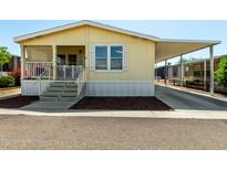 Charming, butterscotch-colored single-story home with a covered porch and convenient covered parking at 8832 E Pueblo Ave # 71, Mesa, AZ 85208