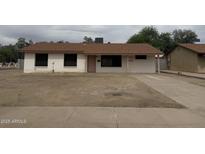 Charming single-story home with a spacious front yard and a quaint exterior at 11802 N 25Th Ave, Phoenix, AZ 85029