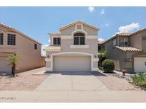 Charming two-story home featuring a neutral color palette, well-maintained landscaping and a two car garage at 1453 E South Fork Dr, Phoenix, AZ 85048