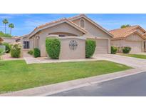 Charming home featuring a well-manicured lawn, desert landscaping, and a warm, inviting facade at 19107 N 94Th Ave, Peoria, AZ 85382