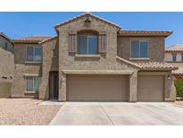 Two-story home featuring a three-car garage, and desert landscaping at 19451 N Leland Rd, Maricopa, AZ 85138