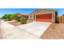 Charming single-story home featuring a two-car garage, low maintenance landscaping, and a classic stucco facade at 5626 W Rainwater Dr, Laveen, AZ 85339