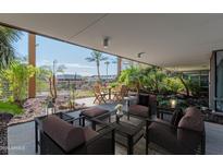 Relaxing outdoor patio with comfortable seating, dining table, and lush tropical landscaping at 7167 E Rancho Vista Dr # 2007, Scottsdale, AZ 85251